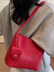 Vintage red leather bucket bag with shoulder strap and matching small pouch