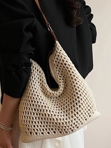 Handmade crochet straw tote bag with brown leather shoulder straps for beach vacation