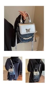 Detail of silver butterfly buckle and pearl chain on denim and metallic crossbody phone bag