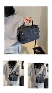 Detail showing woven leather texture and detachable shoulder strap on black handbag
