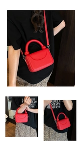 Detail of red lychee grain leather handbag with spherical handle decor and thin strap