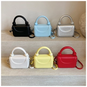 Detailed row of mini crossbody bags in black, blue, silver, white, yellow and red colors