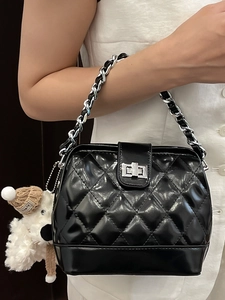Black quilted chain handbag with silver twist lock and cute plush puppy charm accessory