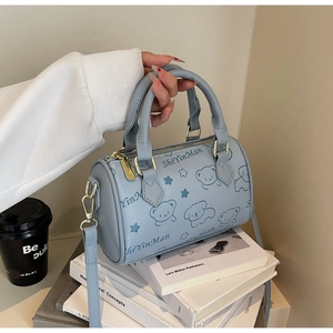 Light blue PU leather Boston bag with bear pattern and gold zipper detail on books