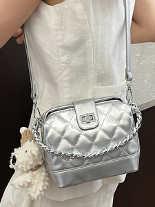 Metallic silver quilted chain bag with turn-lock and cute plush puppy keychain charm