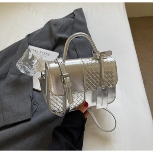 Detail of silver metallic handbag with woven texture and a Fashion & Bags metal tag