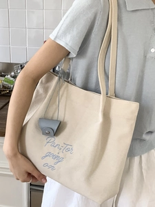 2025 stylish cream canvas tote bag with blue embroidery and long shoulder straps