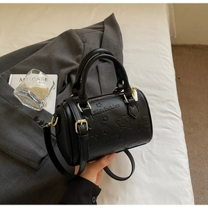 Detail of black Boston bag with 3D bear pattern and elegant gold-tone hardware