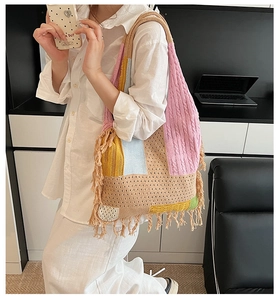 Close-up of colorful knit tote bag with tassel trim detail on the side for daily commute