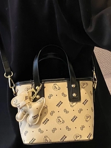 Fashionable beige bucket bag with black bear print and cross-body strap for women