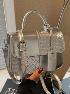 Silver metallic patchwork handbag with woven geometric design and adjustable strap
