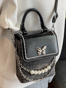 Chic black mini crossbody phone bag with silver butterfly buckle and pearl chain