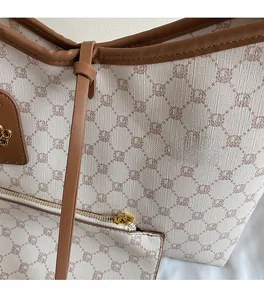 Detailed view of vintage monogram canvas tote bag with premium leather trim and hardware