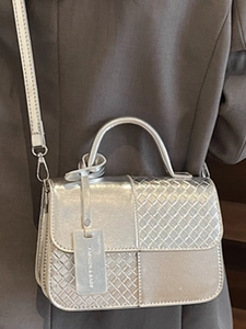 Silver metallic woven crossbody bag with flap and top handle for modern fashion look