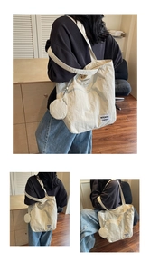 Close-up of a white waterproof nylon tote bag with a small matching round coin purse