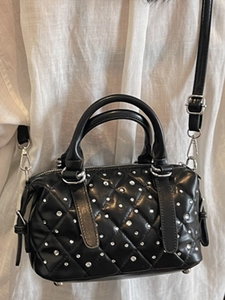Chic black quilted handbag with silver studs and adjustable strap for women