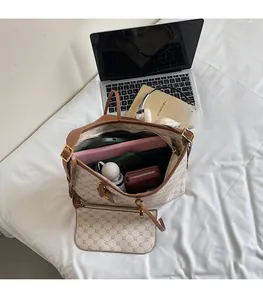 Spacious interior of vintage monogram tote bag showing capacity for laptop and daily items