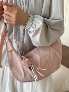 Pink crescent hobo bag with heart pendant and striped rope zipper detail for women