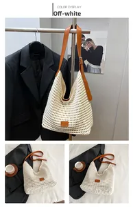 Detail view of off-white crochet tote bag with adjustable brown leather strap and mesh texture