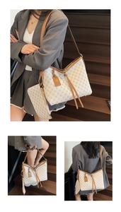 Detail view of large white monogram tote bag with matching pouch and brown leather trim