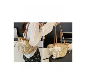 Detail showing versatile carrying ways of a straw tote bag with daisy embroidery