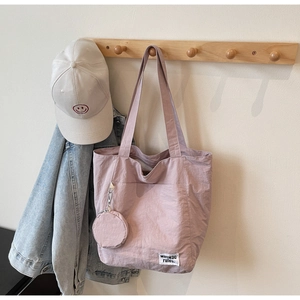 Detail of Morandi pink waterproof nylon tote bag with small round coin purse attachment