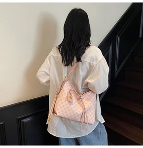 Pink monogram tote bag detail showing slim shoulder straps and high-quality leather texture
