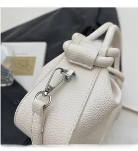 Detail of silver hardware and premium white lychee texture leather on bucket bag