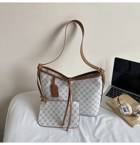 Detail of vintage monogram tote bag with matching zippered pouch and leather tags