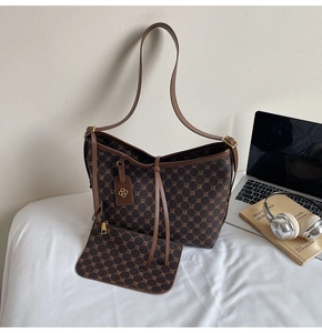 Detail of vintage patterned tote bag set with matching small pouch and gold hardware