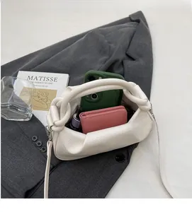 Detailed view of white lychee leather bucket bag showing spacious interior with essentials