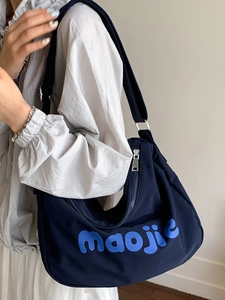 Navy blue canvas tote bag with letter print and adjustable shoulder strap for women