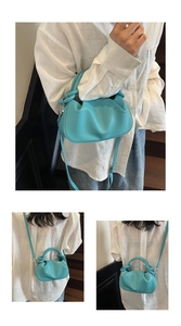 Close-up of turquoise knotted handle and pebble leather texture on a bucket bag