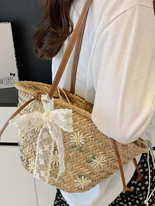 Large straw woven tote bag with daisy embroidery and leather straps for beach holidays