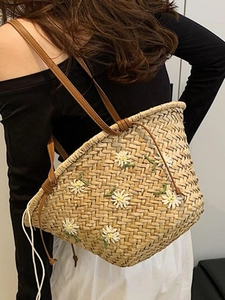 Handmade straw tote bag with daisy embroidery and brown leather straps for summer beach
