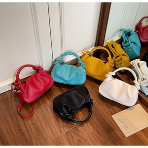 Collection of colorful leather cloud bags featuring knot handles and textured lychee pattern