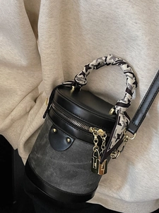 Fashionable cylinder bucket bag with silk scarf handle and gold chain charm decoration