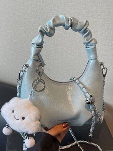 Sky blue pleated leather handbag with ruffled handle and cloud charm accessory