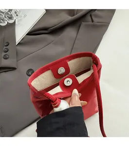 Detailed macro view of the red PU leather bag with magnetic snap closure and pearl accent