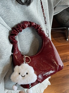 Burgundy ruched cloud bag with glossy texture, metal chain, and cute cloud charm pendant