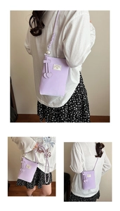 Detail of lavender PU leather phone bag with heart pendant and pearl strap accents