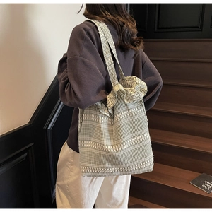 Detailed shot of green gingham tote bag with ruffled edges and large capacity for women