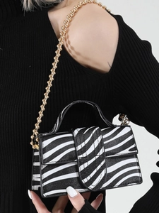 Mini zebra print handbag with golden ball chain strap and faux leather texture