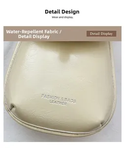 Detail of water-repellent cream leather fabric with silver embossed fashion logo