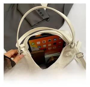 Spacious interior of beige corduroy tote bag holding tablet and personal items