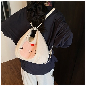 Detail of soft beige corduroy tote bag with cute animal patch embroidery on a model back