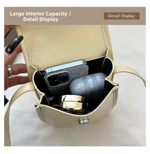 Detail view of large capacity interior for cream PU leather mini crossbody flap bag