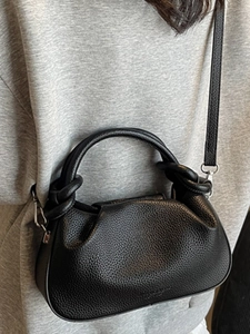 Chic black lychee grain leather cloud bag with twisted handle and crossbody strap