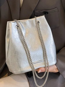 Silver bucket shoulder bag with metallic wrinkled texture and sleek chain straps