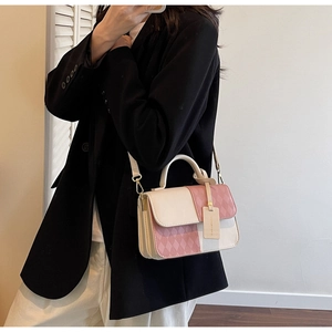 Detailed view of color-block small square bag with diamond quilted leather and gold hardware